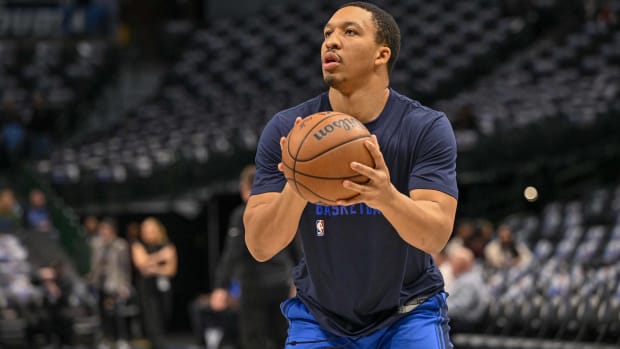 Dallas Mavericks forward Grant Williams shoots a ball in warmups before a game.